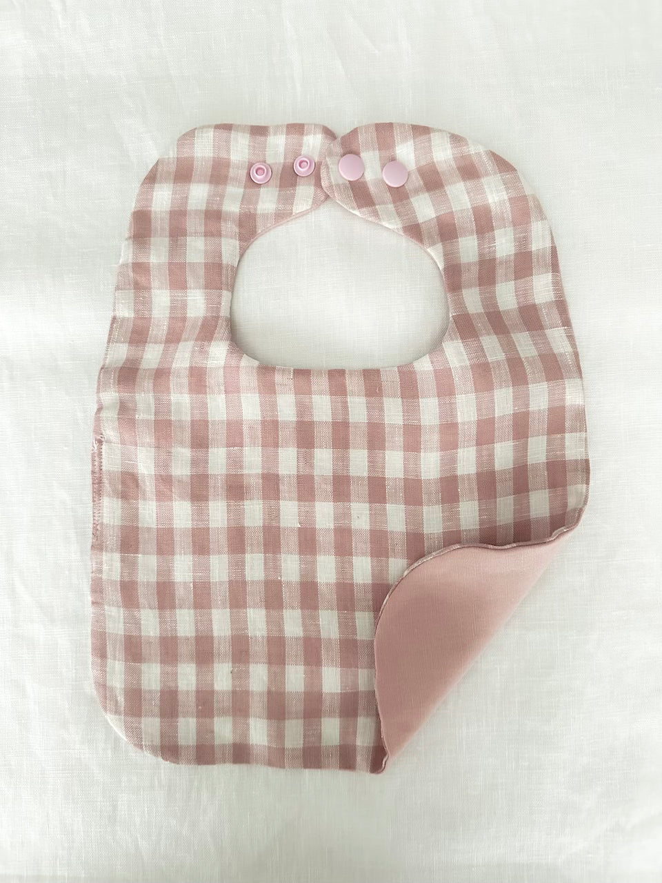 Babies pink check reversible bib