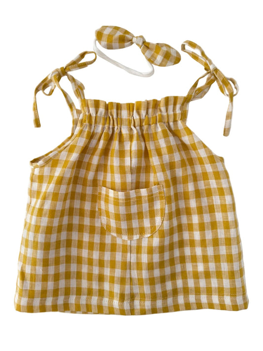 A yellow and white gingham check baby romper set including a sleeveless top with a front pocket and a matching bow headband, displayed on a clean white background.